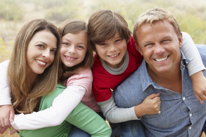 family of four smiling