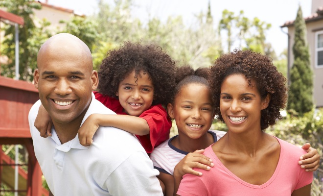 family of four smiling